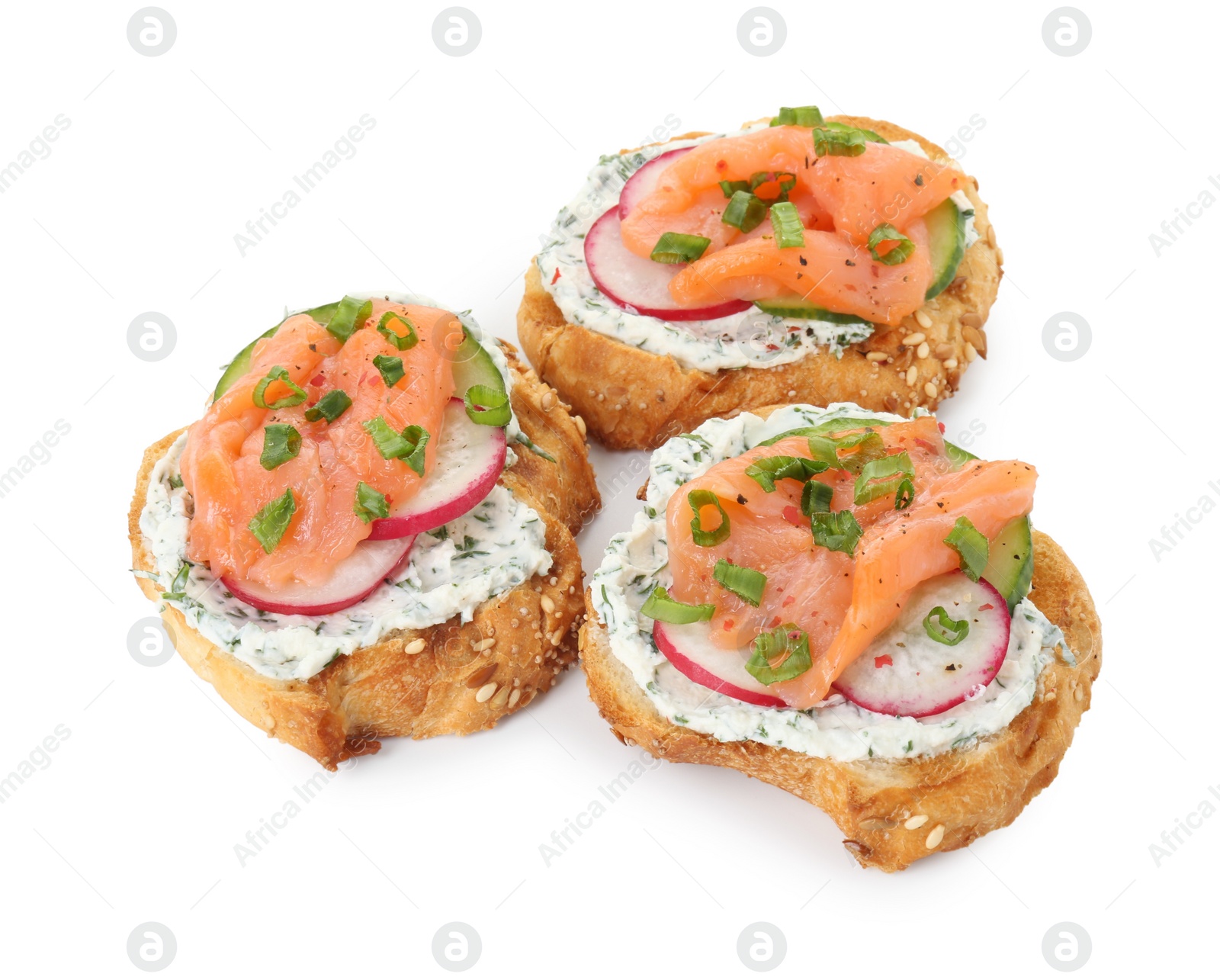 Photo of Tasty canapes with salmon, cucumber, radish and cream cheese isolated on white