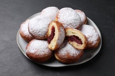 Delicious sweet buns with jam on dark gray table