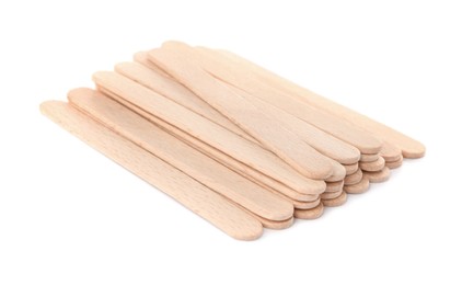 Photo of Disposable wooden spatulas for depilatory wax on white background