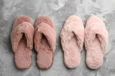 Different stylish soft slippers on grey background, flat lay