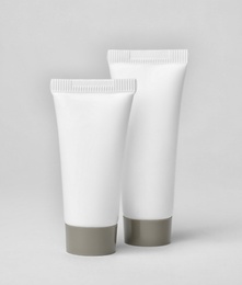 Tubes of cosmetic products on light background