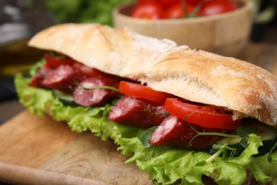 Photo of Delicious sandwich with sausages and vegetables on table, closeup