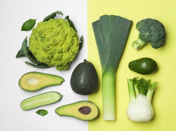 Flat lay composition with fresh ripe vegetables on color background