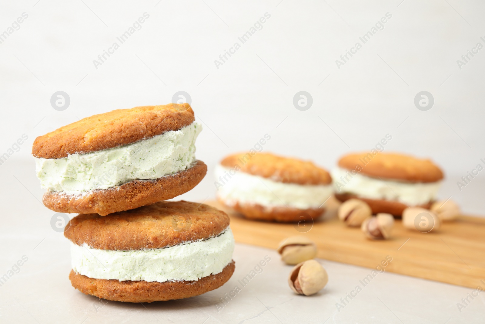 Photo of Sweet delicious ice cream cookie sandwiches on table, space for text