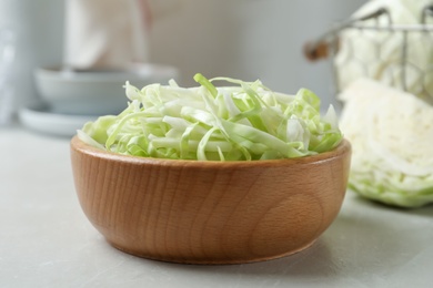 Photo of Fresh shredded cabbage on light table, closeup