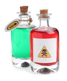 Photo of Glass bottles of poisons with warning signs on white background