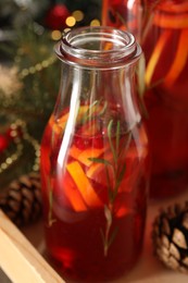 Aromatic punch drink with citrus fruits on table, closeup