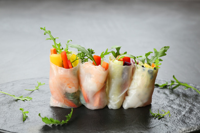 Delicious rolls wrapped in rice paper served on table