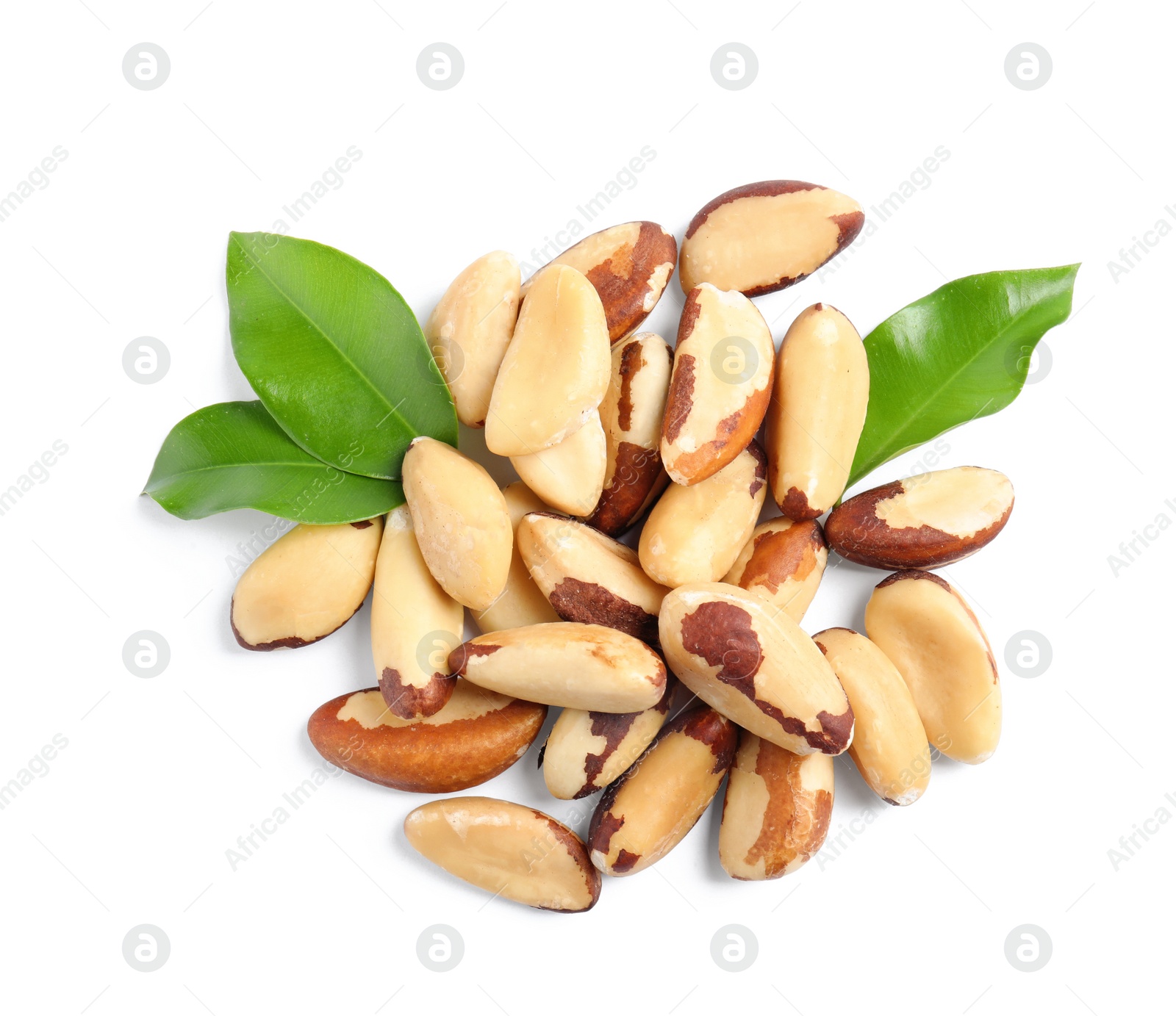Photo of Brazil nuts with green leaves on white background, top view
