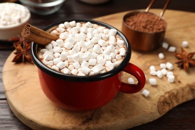 Tasty hot chocolate with marshmallows on wooden table, closeup