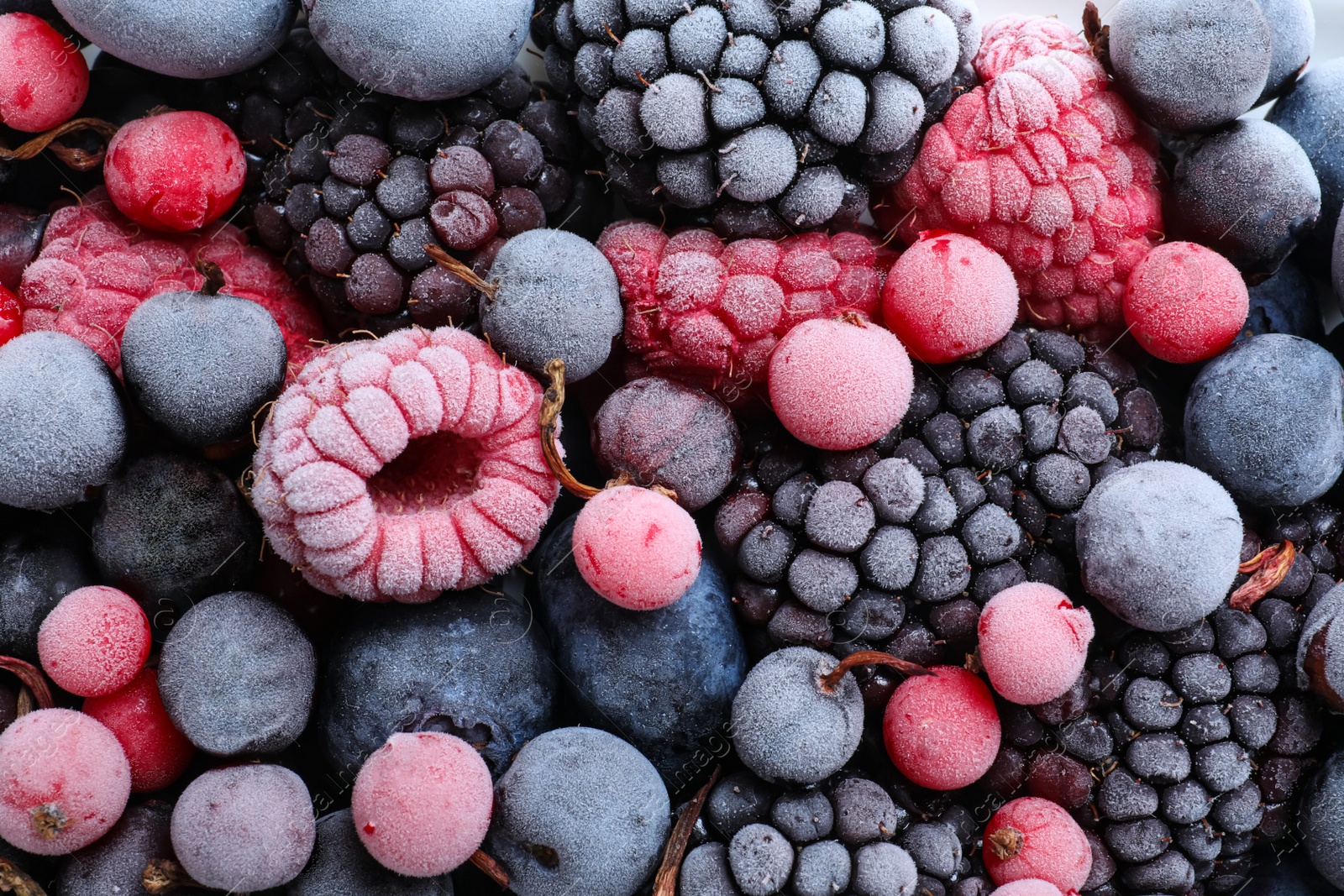 Photo of Mix of different frozen berries as background, top view