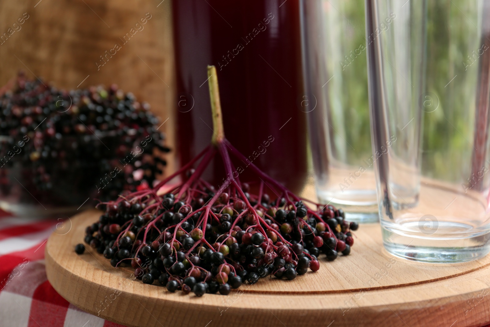 Photo of Sambucus berries and elderberry drink on table, closeup