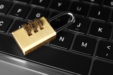 Photo of Cyber security. Padlock on laptop, closeup view