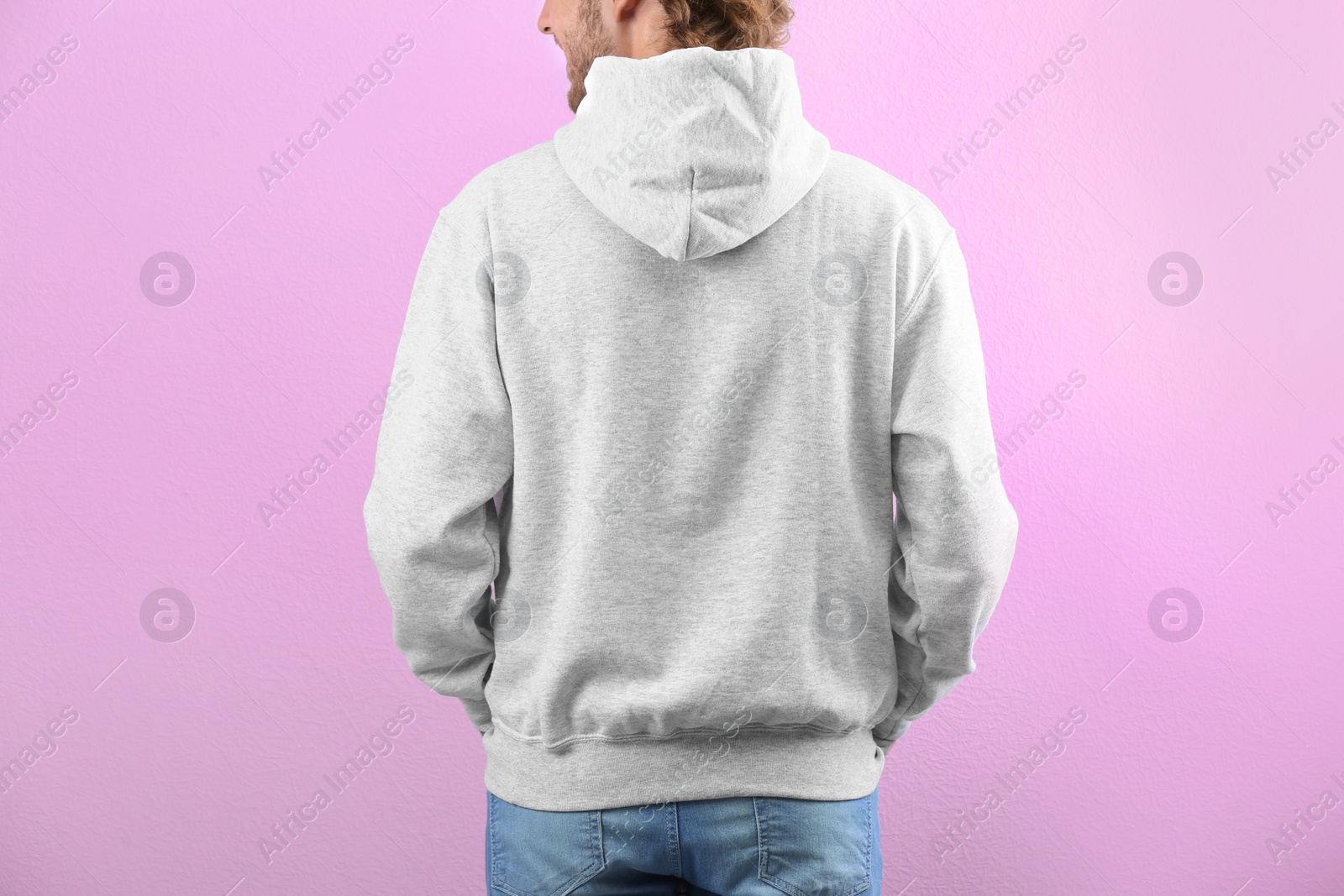 Photo of Man in hoodie sweater on color background. Space for design