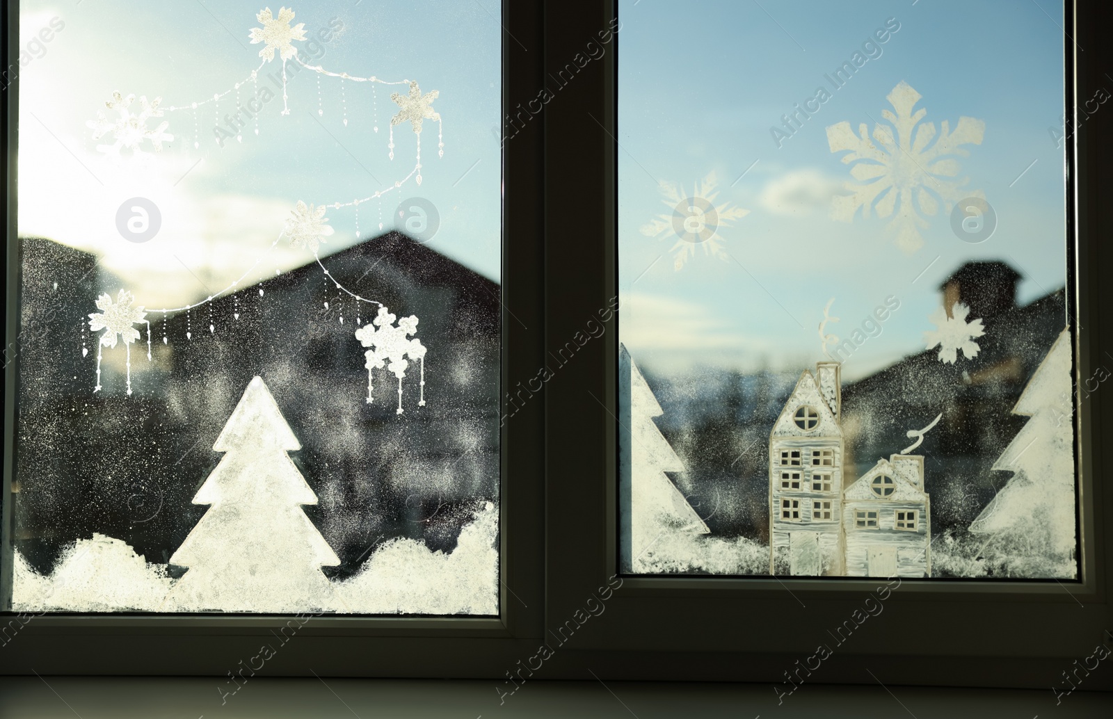 Photo of Beautiful drawing made with artificial snow on window. Christmas decor