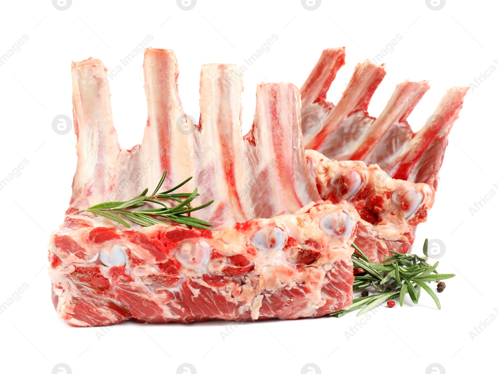 Photo of Raw ribs with rosemary and pepper on white background