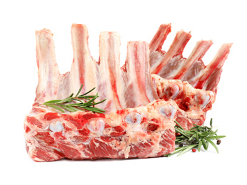 Raw ribs with rosemary and pepper on white background