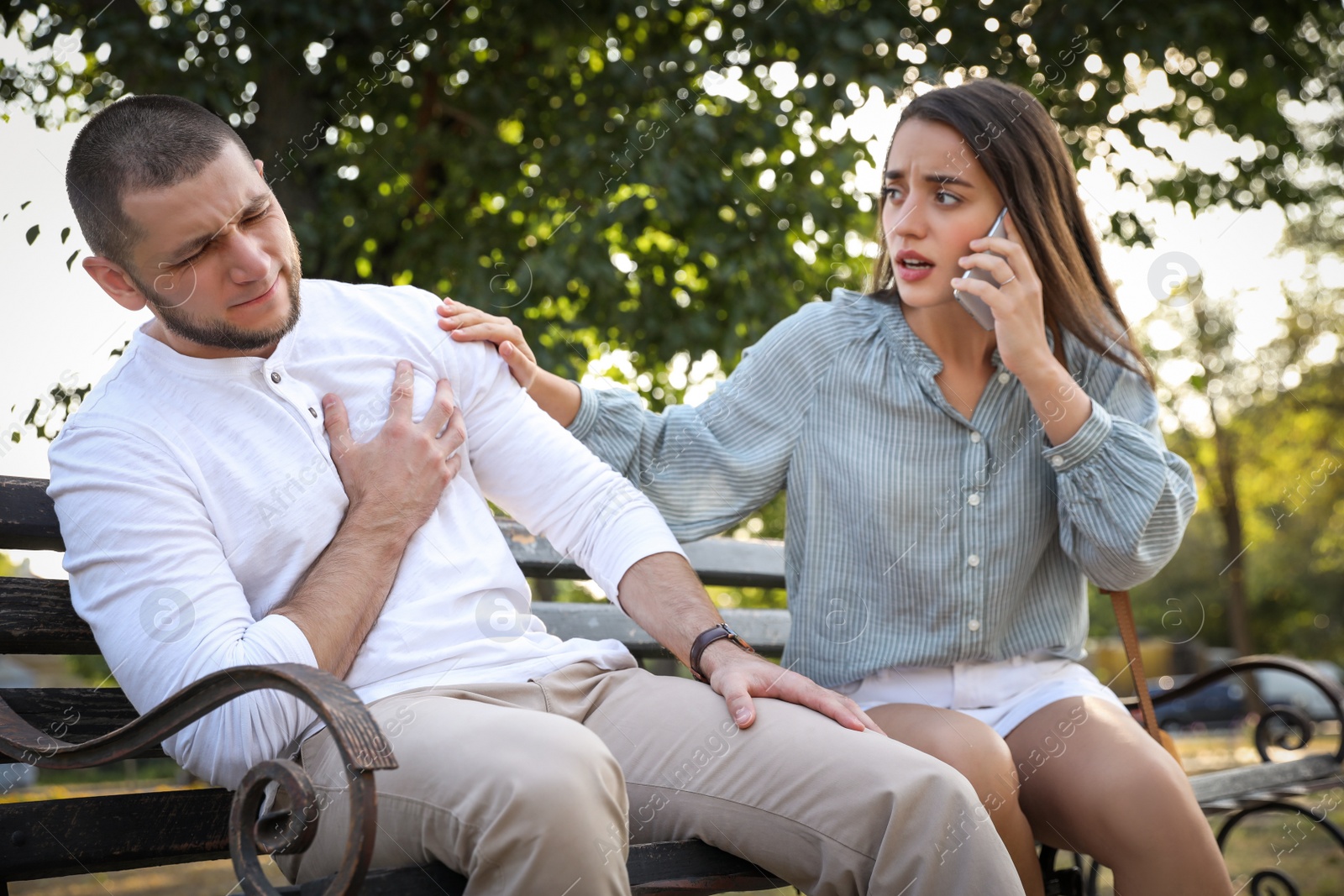 Photo of Woman calling ambulance to help man with heart attack in park