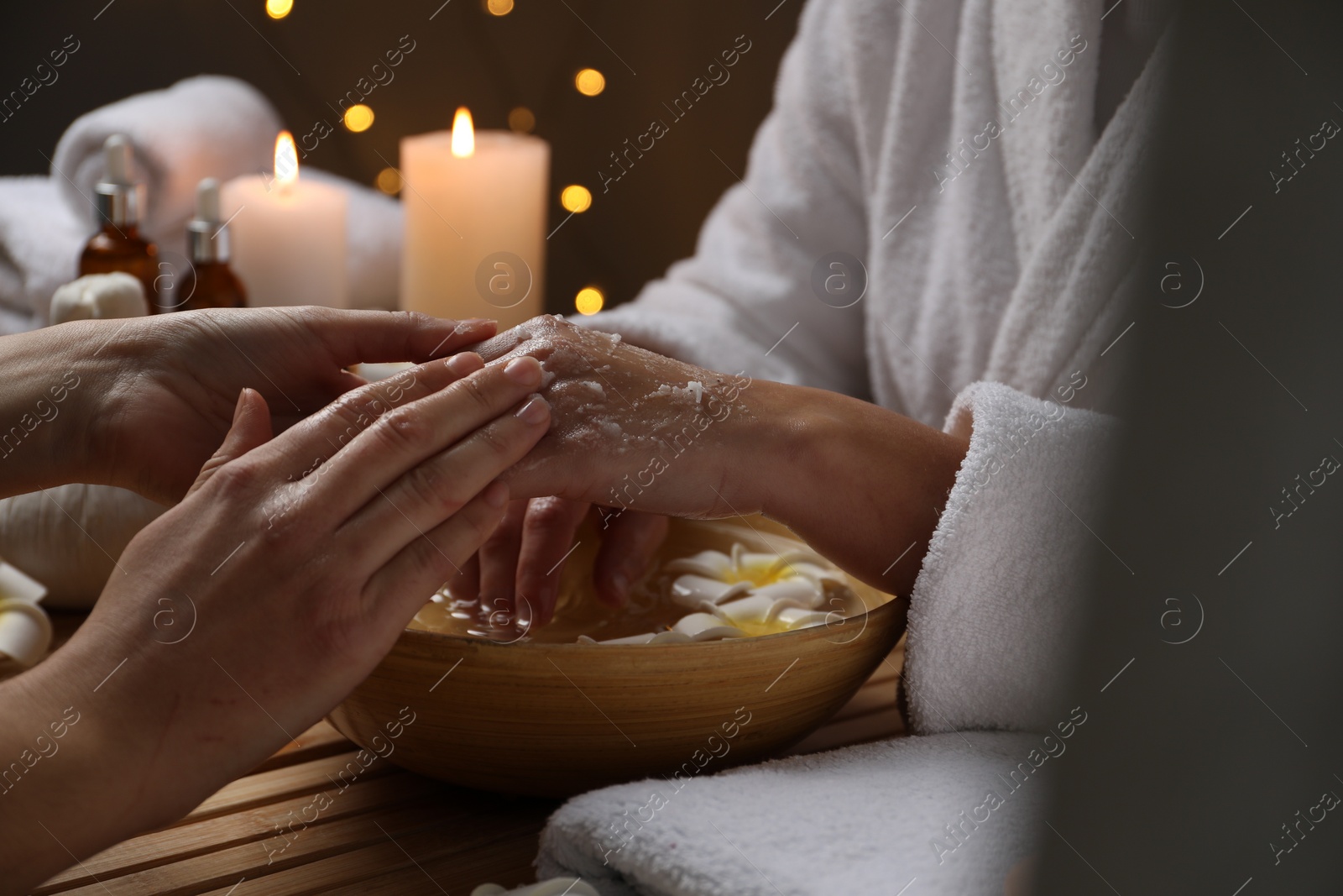 Photo of Woman receiving hand treatment at table in spa, closeup