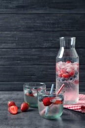 Photo of Natural lemonade with berries in glassware on table