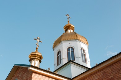 Photo of Village church against blue sky, low angle view
