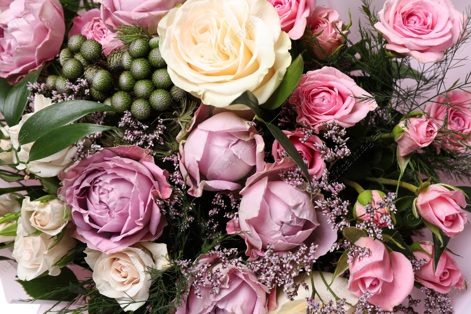 Photo of Beautiful bouquet with roses as background, closeup