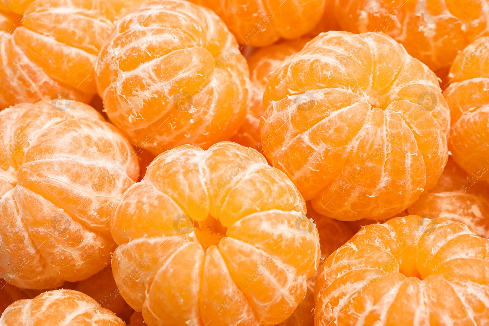 Photo of Peeled fresh ripe tangerines as background, closeup