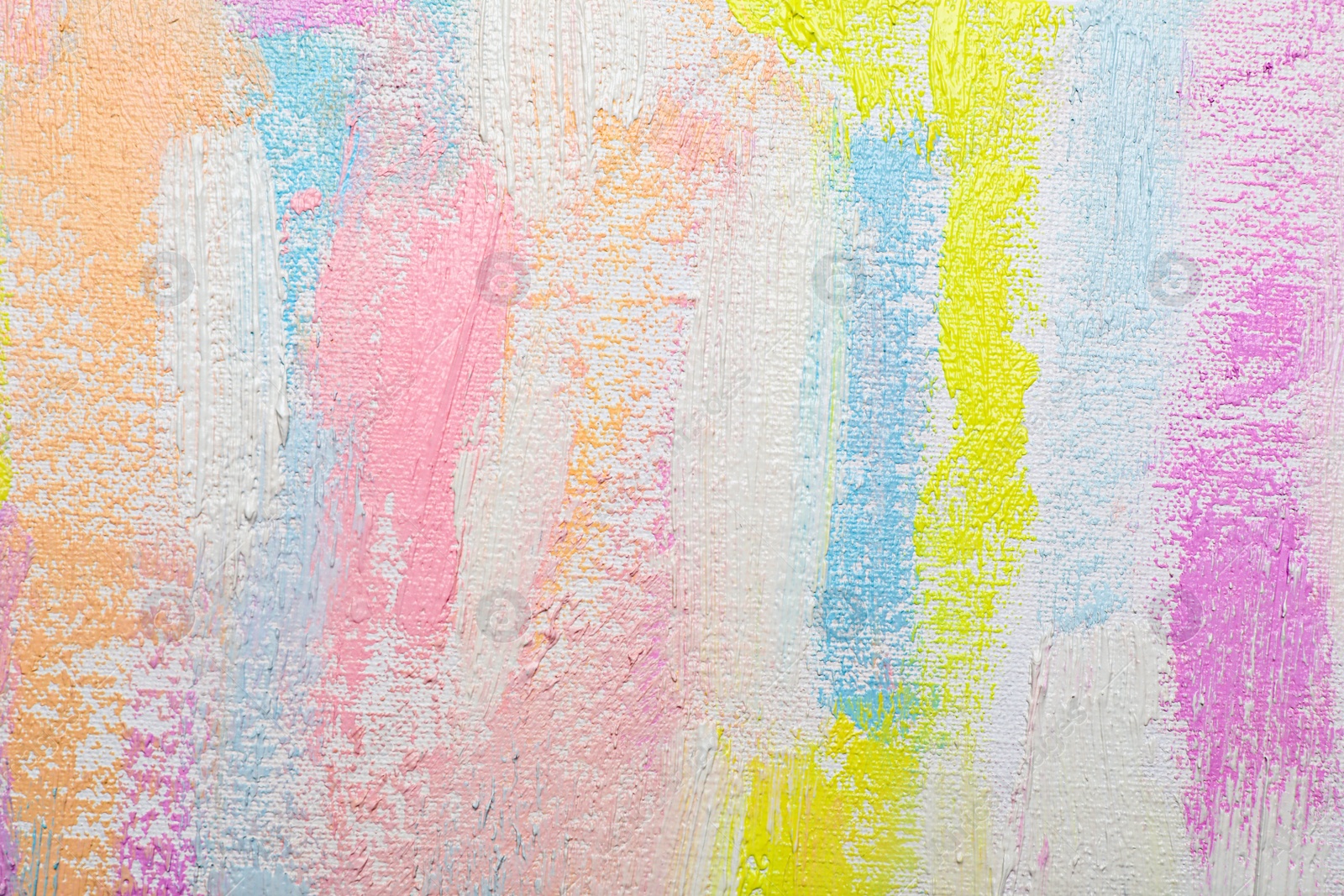 Photo of Strokes of different pastel acrylic paints on white canvas, closeup