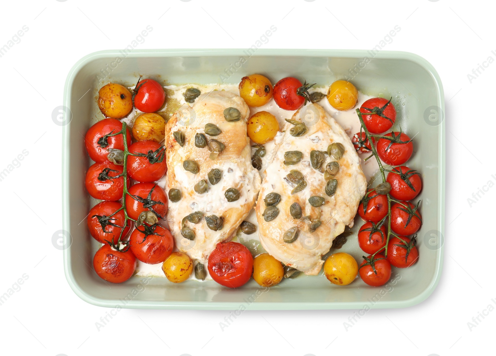 Photo of Delicious chicken fillets with capers, tomatoes and sauce in baking dish isolated on white, top view