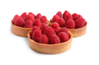 Tartlets with fresh raspberries isolated on white. Delicious dessert