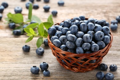 Photo of Tasty fresh blueberries on wooden table, closeup