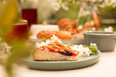 Photo of Stylish table setting with beautiful spring flowers, fruit drink and pie in garden