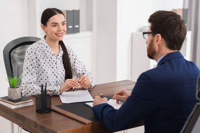 Woman having meeting with lawyer in office, selective focus