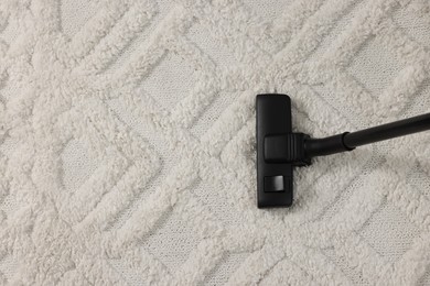 Hoovering carpet with vacuum cleaner, top view. Space for text