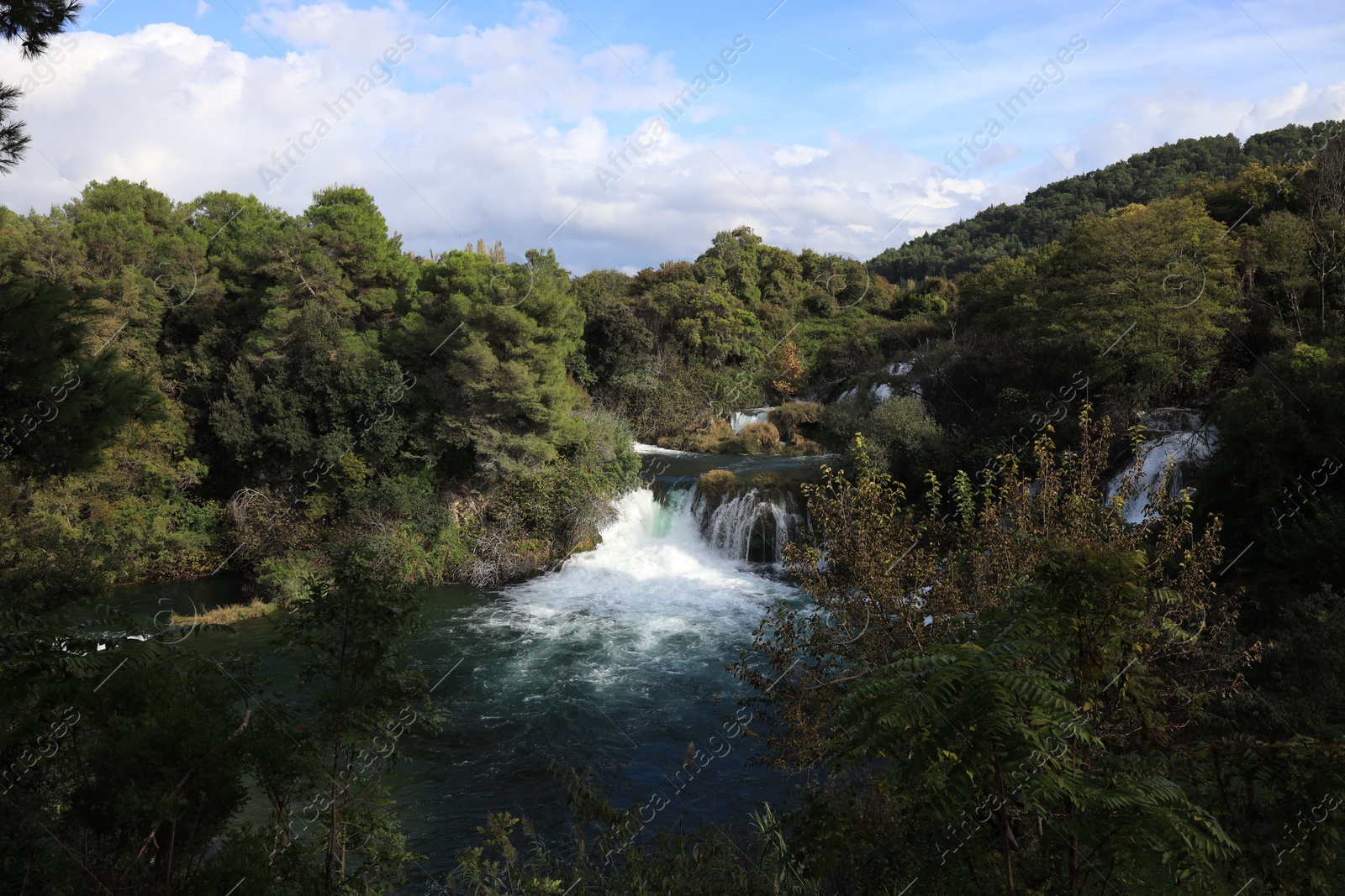 Photo of Picturesque view of beautiful waterfall and rocks outdoors