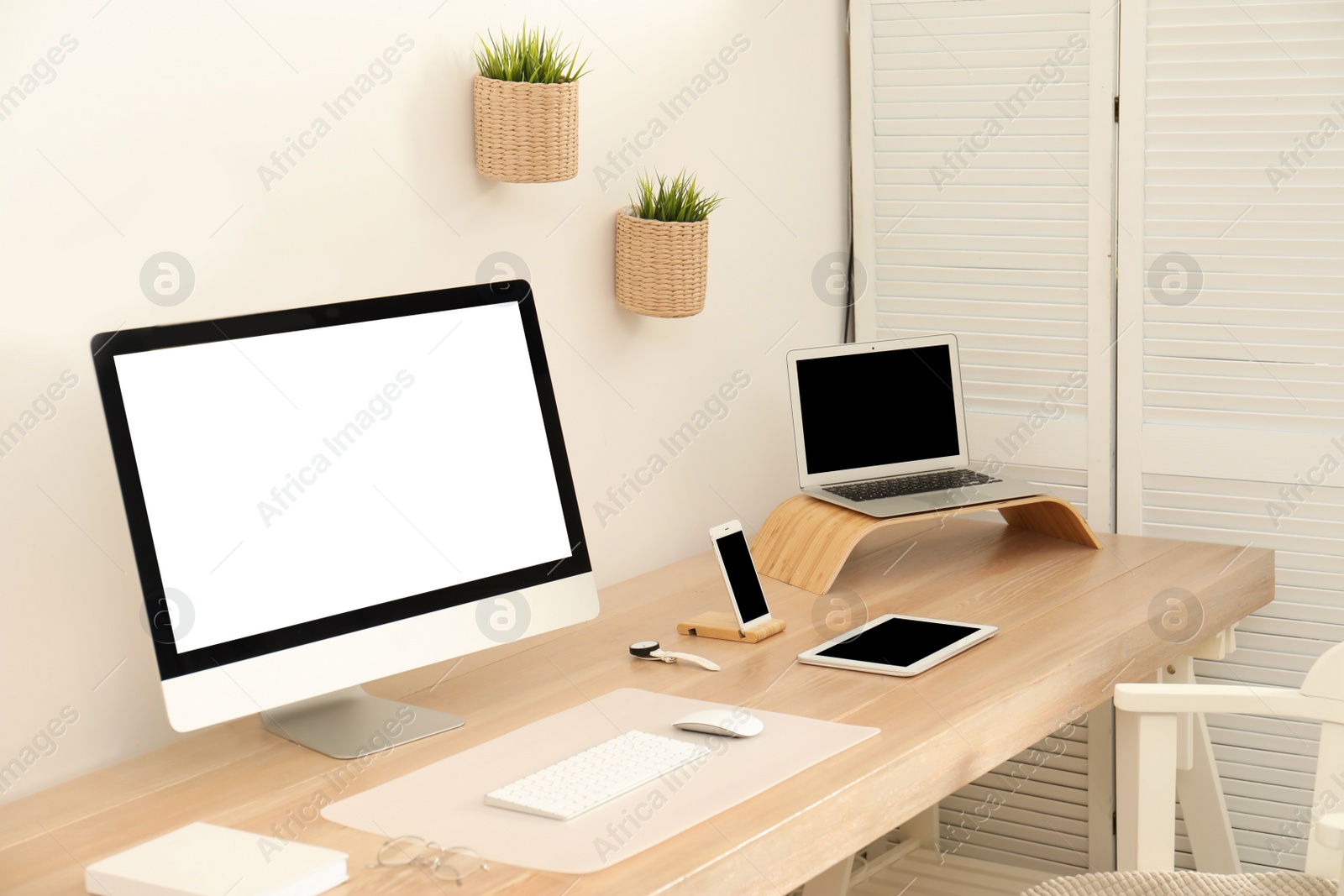 Photo of Stylish workplace interior with modern computer on table. Mockup for design