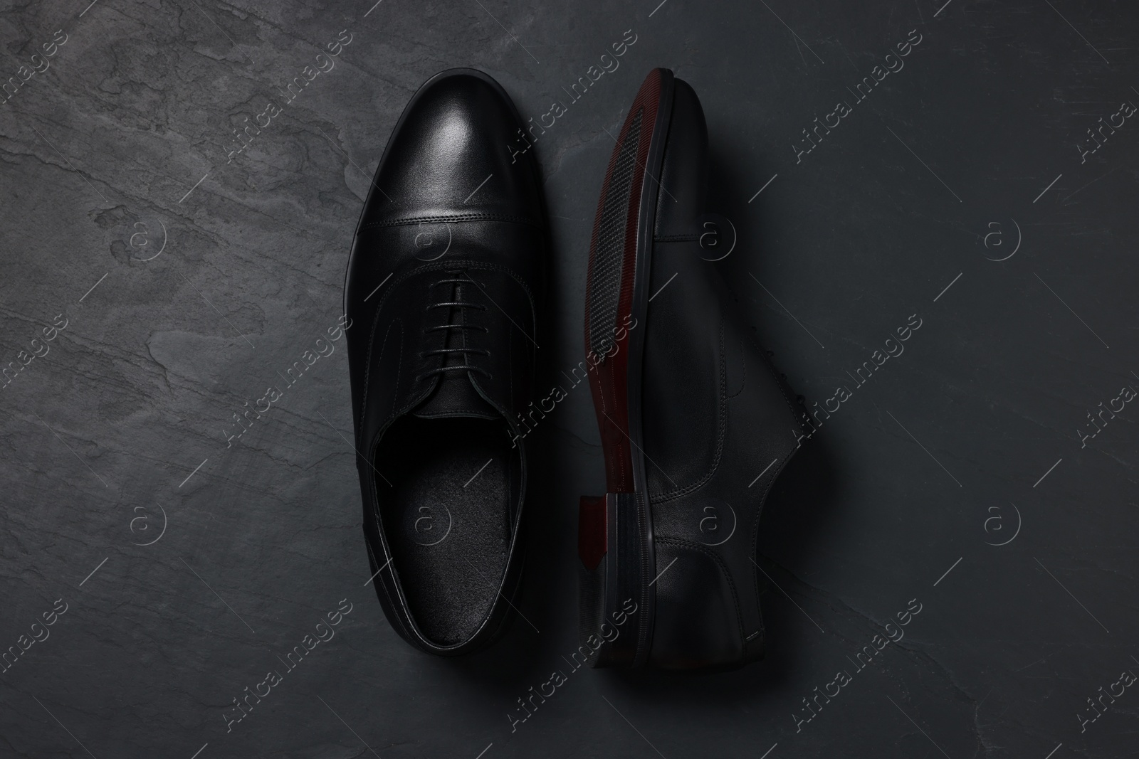 Photo of Pairleather men shoes on black surface, top view