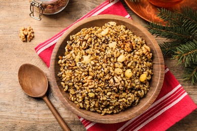 Photo of Traditional Christmas slavic dish kutia served on wooden table, flat lay