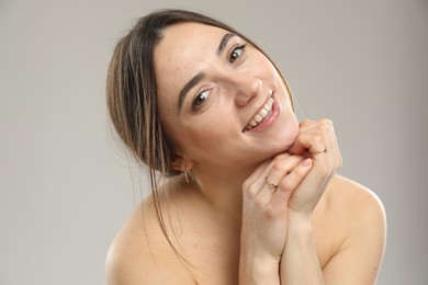 Photo of Portrait of beautiful woman on grey background