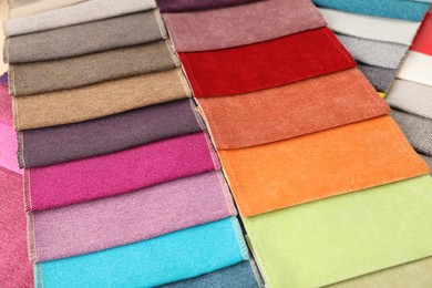 Photo of Fabric samples of different colors as background