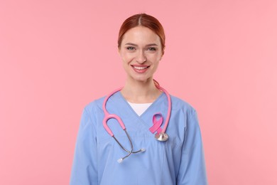 Photo of Mammologist with pink ribbon on color background. Breast cancer awareness