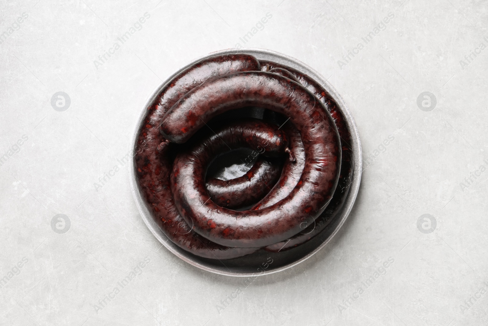 Photo of Tasty blood sausages on light grey table, top view