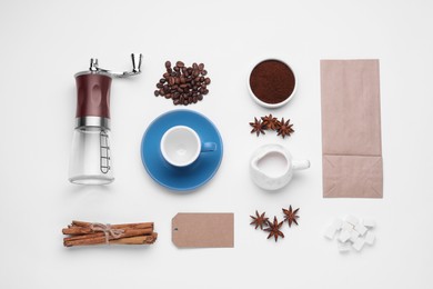 Photo of Flat lay composition with ground coffee, grinder and roasted beans on white background