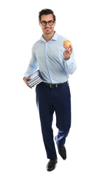 Photo of Young male teacher with books and apple on white background
