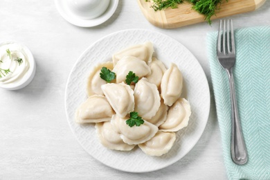 Photo of Flat lay composition with tasty dumplings served on white table