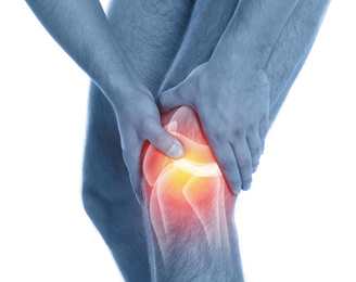 Image of Man suffering from knee pain on white background, closeup. Color tone effect