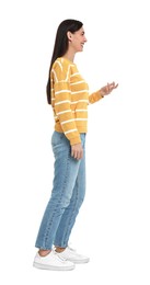 Photo of Happy woman in jeans and sweater on white background