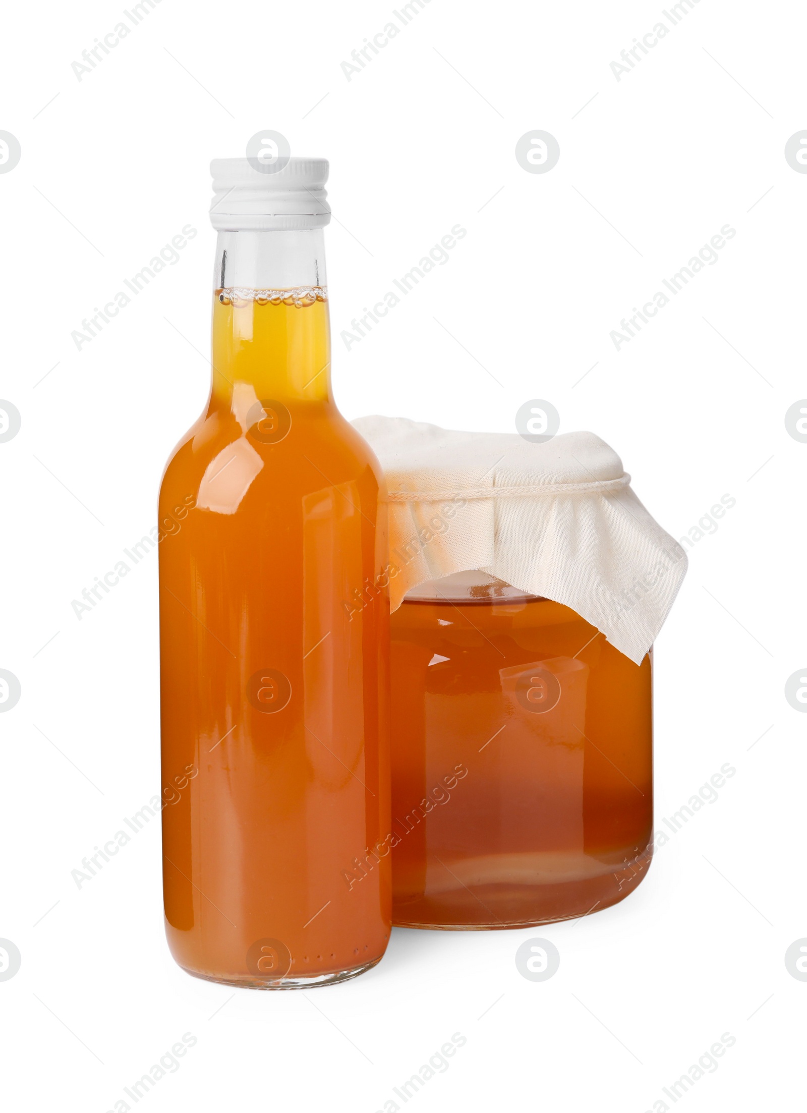 Photo of Delicious kombucha in glass bottle and jar isolated on white