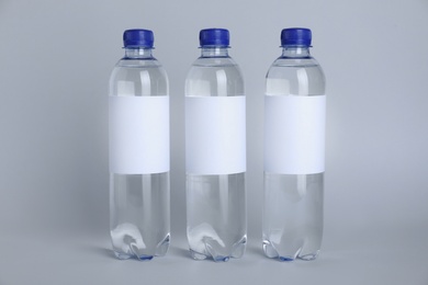 Plastic bottles with soda water on light background