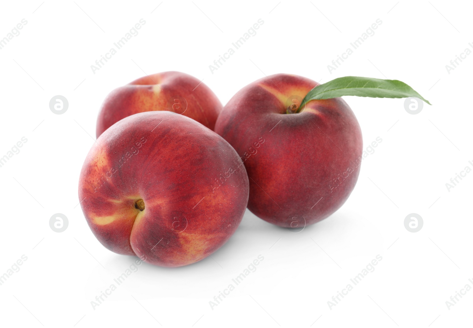 Photo of Delicious ripe peaches with leaf isolated on white